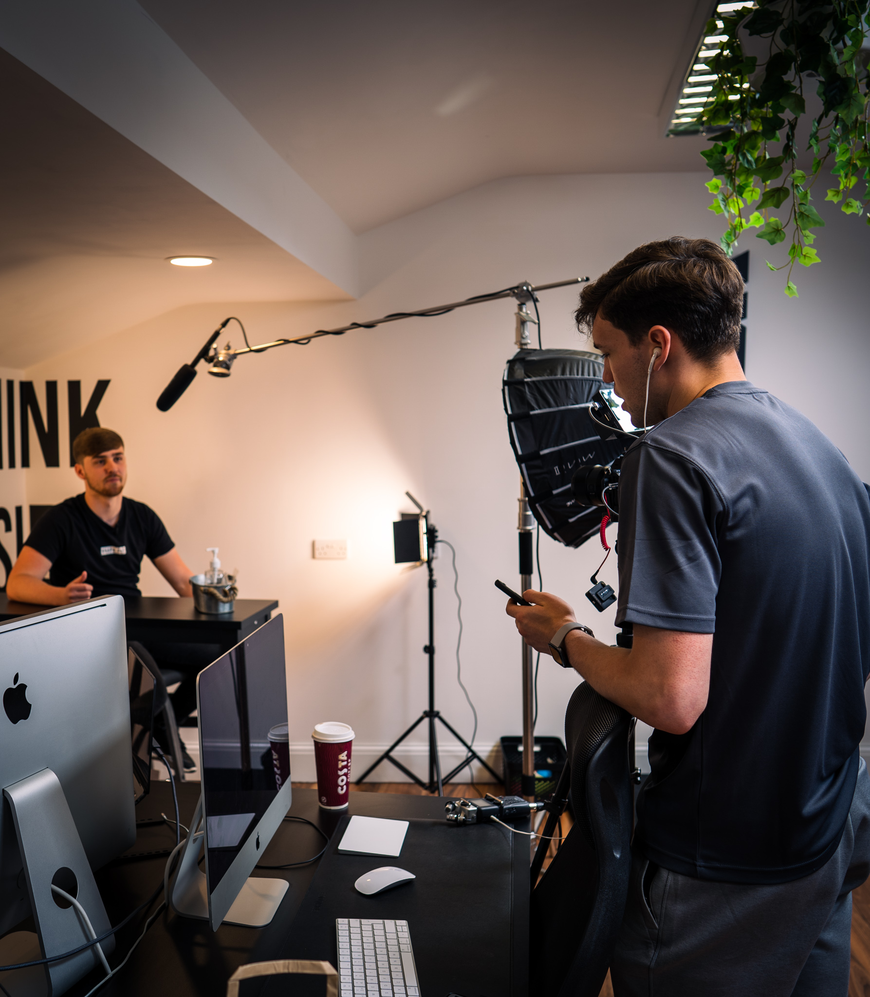 Reece standing behind the camera directing someone at GraphFit