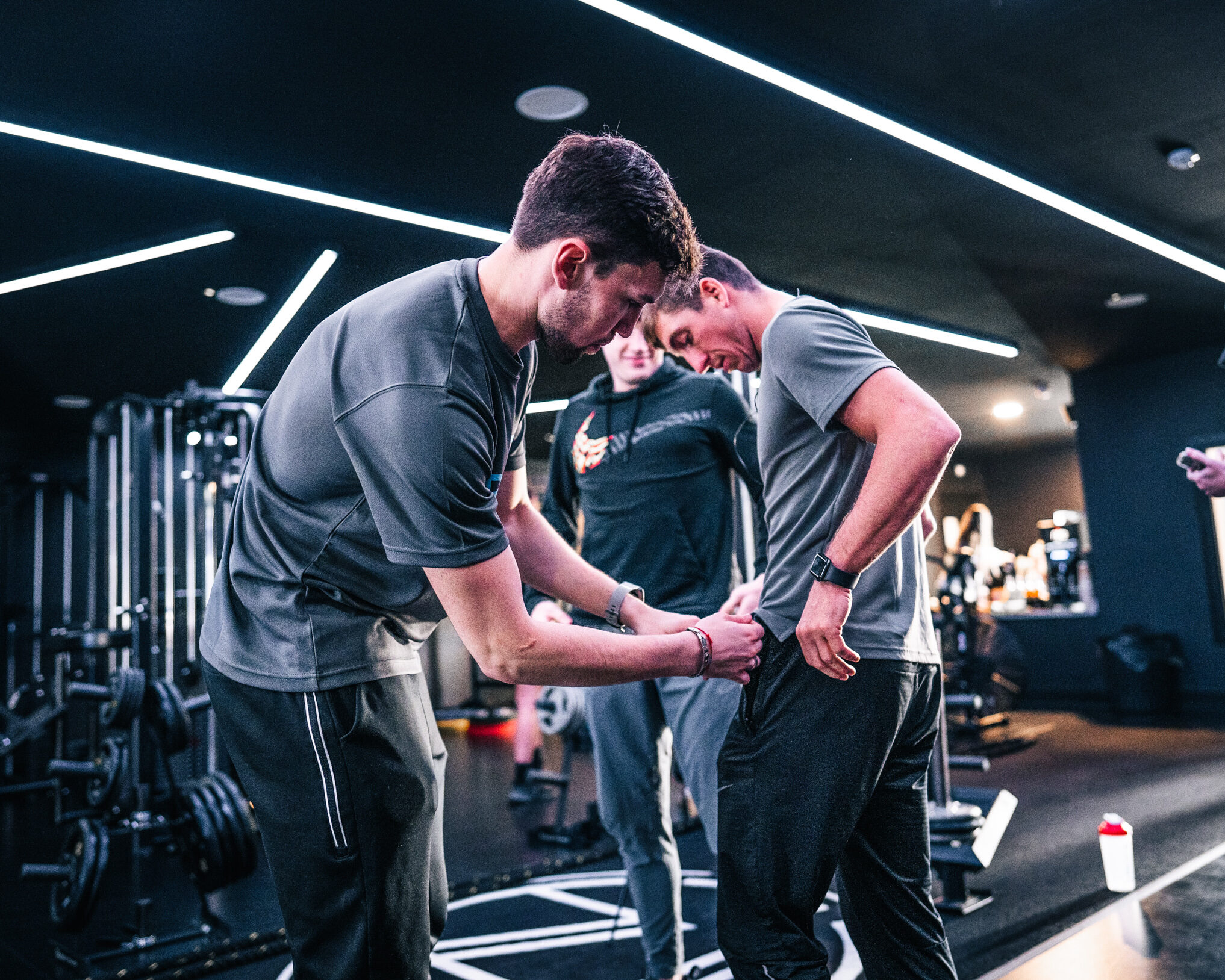 Interviewer fixing mic to man before interview